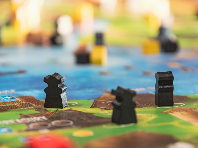 Designers balancing a board game around the studio table